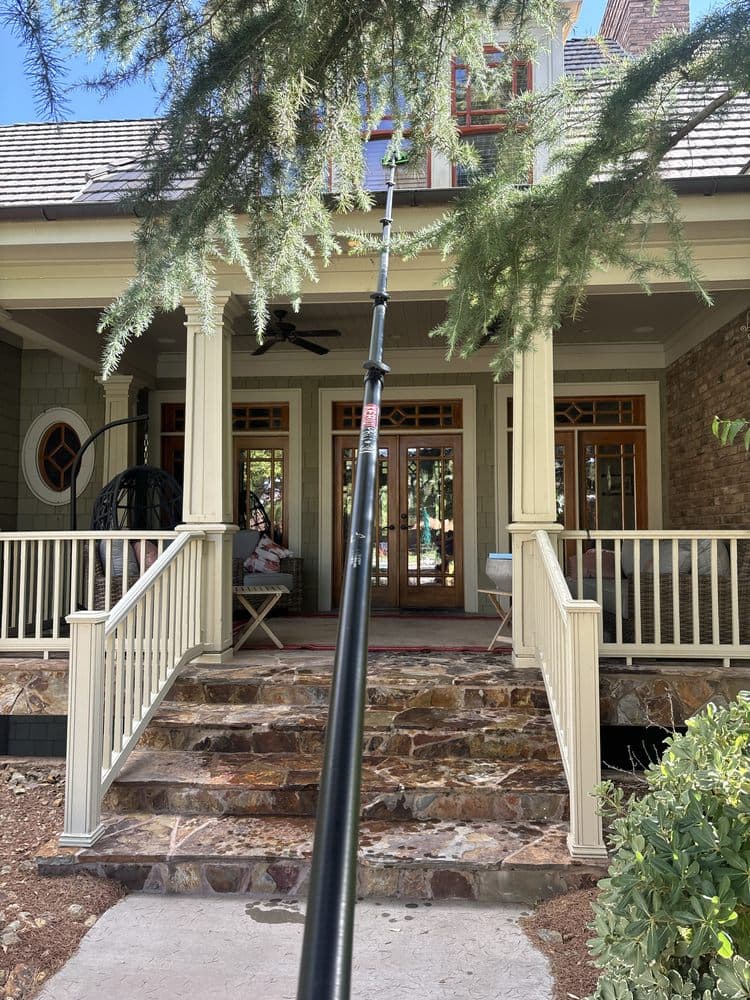 Waterfed pole reaching a covered front porch